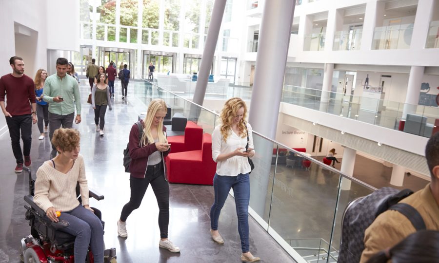 students-walk-and-talk-using-mobile-devices-in-uni